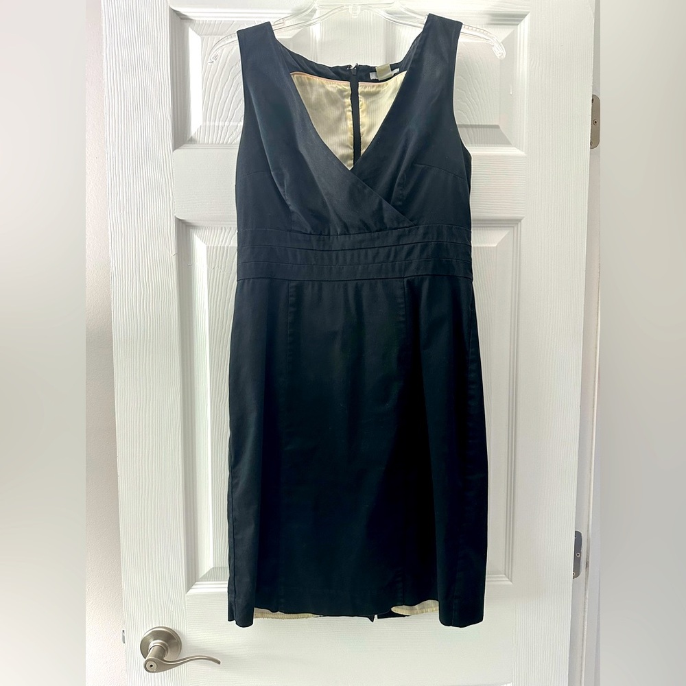 Classic black dress. V neck. Zippered back is completely covered.